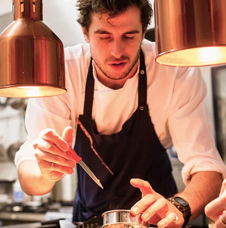 A chef preparing food in a professional kitchen